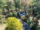 Aerial view of the house surrounded by lush trees and greenery at 724 Se Cowan Se Rd, Conyers, GA 30094