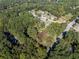 An aerial view of the property in wooded area with surrounding neighborhood at 724 Se Cowan Se Rd, Conyers, GA 30094