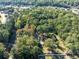 Aerial view of the property showing surrounding trees, neighborhood, and lush greenery at 724 Se Cowan Se Rd, Conyers, GA 30094