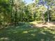 Expansive backyard with lush green grass and mature trees, creating a private and serene outdoor space at 724 Se Cowan Se Rd, Conyers, GA 30094