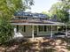 Two-story home featuring a covered porch with white pillars and a black front door at 724 Se Cowan Se Rd, Conyers, GA 30094