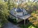 Aerial view of the back of the house with a wooden deck and lower patio area at 724 Se Cowan Se Rd, Conyers, GA 30094