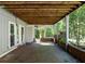 Rear exterior patio space featuring brickwork, three doors, and a wooden support for the deck above at 724 Se Cowan Se Rd, Conyers, GA 30094