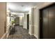 Hallway with carpet, wall sconces and elevator access at 795 Hammond Dr # 1812, Atlanta, GA 30328