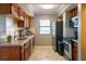 A view of the kitchen, featuring wood cabinets, light countertops, and stainless steel appliances at 795 Hammond Dr # 1812, Atlanta, GA 30328