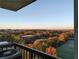 Expansive balcony view of fall foliage and a well-maintained athletic field at 795 Hammond Dr # 1812, Atlanta, GA 30328