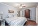 Bedroom with hardwood floors, a ceiling fan, and a large dresser at 1971 Commonwealth Way, Grayson, GA 30017