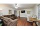 Living room with hardwood floors, a ceiling fan, and a comfortable sectional sofa at 1971 Commonwealth Way, Grayson, GA 30017