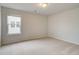 Neutral bedroom with a large window and carpeted floor at 246 Arnewood Cir, Mcdonough, GA 30253