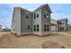 View of the two-story home showing the side and rear exterior with a large yard and ample windows at 246 Arnewood Cir, Mcdonough, GA 30253