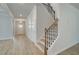 Hallway with staircase and durable, attractive, light-colored wood flooring at 246 Arnewood Cir, Mcdonough, GA 30253