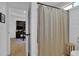 Bright bathroom featuring a shower with neutral-toned curtain and natural wood stool at 2550 Belaire Dr, Cumming, GA 30041