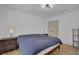 Bedroom with a blue duvet, modern lighting fixture and light wood floors at 2550 Belaire Dr, Cumming, GA 30041