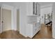 Hallway features wood floors, white cabinets and stairway to upper floor at 2550 Belaire Dr, Cumming, GA 30041