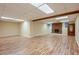 Large basement with light hardwood flooring, fireplace, and window views at 4610 Riversound Drive, Snellville, GA 30039