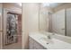 Bathroom features a clean single vanity, large mirror, and tub with shower at 4610 Riversound Drive, Snellville, GA 30039