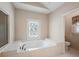 Large soaking tub in bathroom with privacy window and a separate access to the commode at 4610 Riversound Drive, Snellville, GA 30039