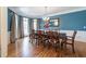 Formal dining room with hardwood floors, bay window, and elegant chandelier at 4610 Riversound Drive, Snellville, GA 30039