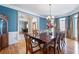 Open-concept dining area with hardwood floors, chandelier, and natural light at 4610 Riversound Drive, Snellville, GA 30039