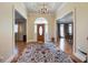 Spacious foyer featuring hardwood floors, a chandelier, and a wooden front door at 4610 Riversound Drive, Snellville, GA 30039