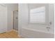 Bathroom featuring a soaking tub, glass-enclosed shower, and large window at 10231 Deep Creek Pl, Union City, GA 30291