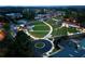 Aerial view of a beautifully lit outdoor amphitheater with lawn seating in a vibrant community setting at 118 Village Green Ave, Woodstock, GA 30189