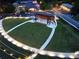 Aerial view of community amphitheater featuring a covered stage and expansive lawn seating for outdoor events at 118 Village Green Ave, Woodstock, GA 30189
