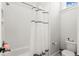 Bright bathroom showcases subway tile shower and black-striped curtain at 118 Village Green Ave, Woodstock, GA 30189