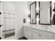 Elegant bathroom features dual sinks, modern lighting, and framed mirrors at 118 Village Green Ave, Woodstock, GA 30189