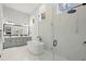 Elegant bathroom featuring a modern soaking tub, glass-enclosed shower, and a dual vanity with stylish fixtures at 118 Village Green Ave, Woodstock, GA 30189