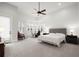 Expansive Primary bedroom with vaulted ceilings and large picture windows at 118 Village Green Ave, Woodstock, GA 30189