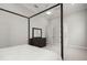 Airy bedroom with a four-poster bed, dresser, and ample closet space showcases comfort and style at 118 Village Green Ave, Woodstock, GA 30189