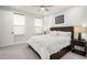 Bright bedroom features a plush bed, modern furnishings, and neutral color palette at 118 Village Green Ave, Woodstock, GA 30189