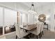 Bright dining area featuring modern chandelier, and seamless connection to the backyard at 118 Village Green Ave, Woodstock, GA 30189