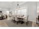 Bright dining area featuring modern chandelier, and seamless connection to the backyard at 118 Village Green Ave, Woodstock, GA 30189
