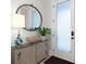 Inviting entryway featuring stylish decor, a decorative mirror, and a textured glass door for added privacy at 118 Village Green Ave, Woodstock, GA 30189