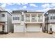 Charming two-story home featuring a dual garage and a quaint second-story balcony, perfect for suburban living at 118 Village Green Ave, Woodstock, GA 30189