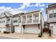 Charming two-story home featuring a dual garage and a quaint second-story balcony, perfect for suburban living at 118 Village Green Ave, Woodstock, GA 30189