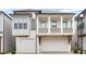 Charming two-story home featuring a dual garage and a quaint second-story balcony, perfect for suburban living at 118 Village Green Ave, Woodstock, GA 30189