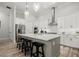 Modern kitchen featuring a large island, stainless steel appliances, and stylish pendant lighting at 118 Village Green Ave, Woodstock, GA 30189