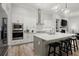 Modern kitchen featuring a large island, stainless steel appliances, and stylish pendant lighting at 118 Village Green Ave, Woodstock, GA 30189