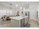 Open-concept kitchen with a large island flowing into the dining and living areas, perfect for entertaining at 118 Village Green Ave, Woodstock, GA 30189