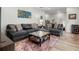 Bright living room features neutral color palettes, comfortable seating, and hardwood floors at 118 Village Green Ave, Woodstock, GA 30189