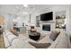 Bright living room featuring a modern fireplace, and seamless connection to the kitchen at 118 Village Green Ave, Woodstock, GA 30189