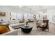 Bright living room featuring a modern fireplace, and seamless connection to the dining room and kitchen at 118 Village Green Ave, Woodstock, GA 30189