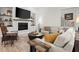 Bright living room featuring a modern fireplace, and seamless connection to the backyard at 118 Village Green Ave, Woodstock, GA 30189