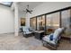 Covered patio includes outdoor seating, ceiling fan, and views of the home's interior at 118 Village Green Ave, Woodstock, GA 30189