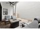 Cozy covered patio featuring an outdoor fireplace and comfortable seating at 118 Village Green Ave, Woodstock, GA 30189