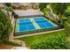 Aerial view showcases community pickleball courts and bocce ball, offering recreational activities for residents at 118 Village Green Ave, Woodstock, GA 30189