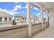 Covered porch with view of neighborhood homes on a sunny day at 118 Village Green Ave, Woodstock, GA 30189
